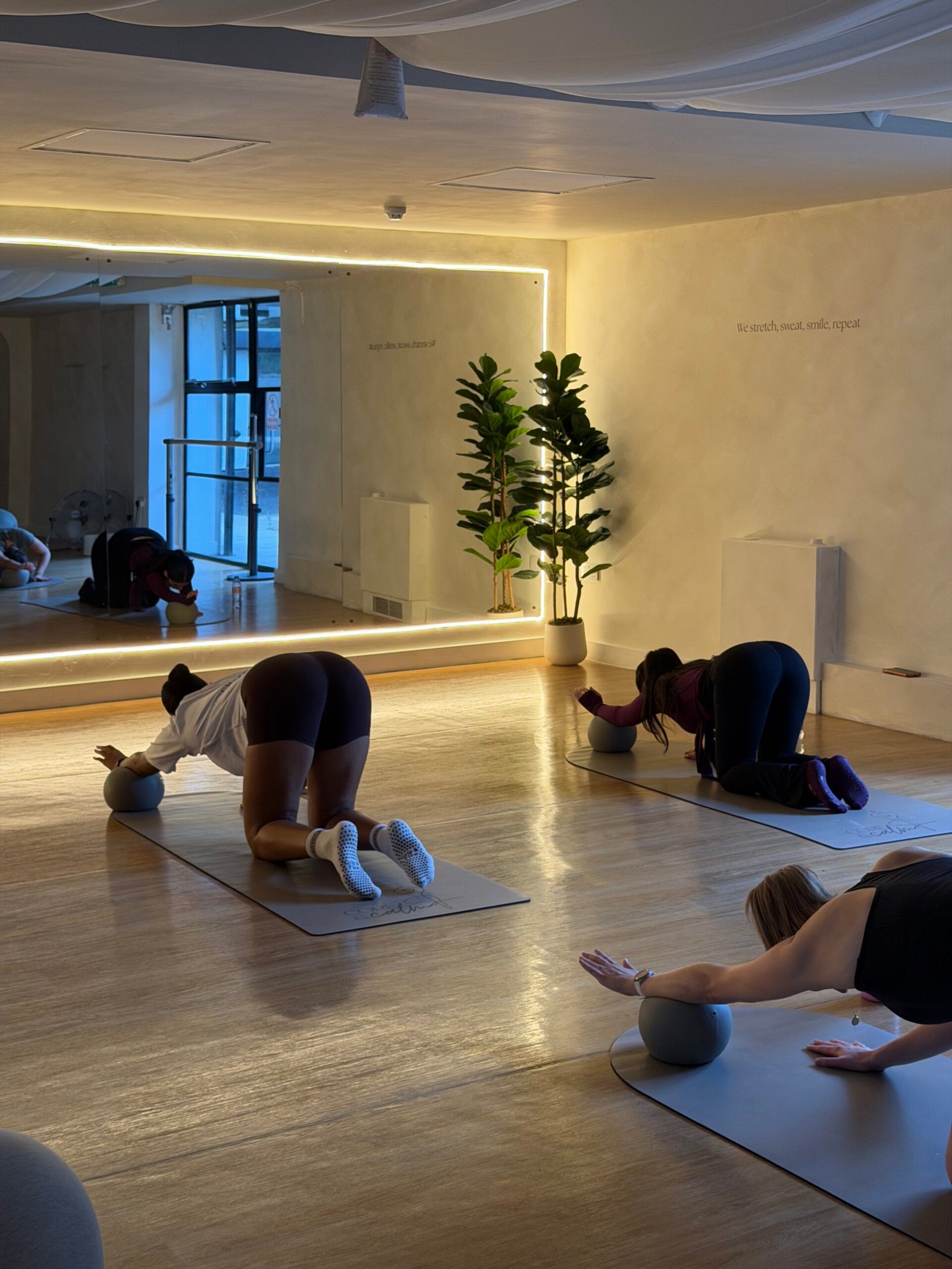 Instructor welcoming a new client to the Hackney Wick Pilates studio